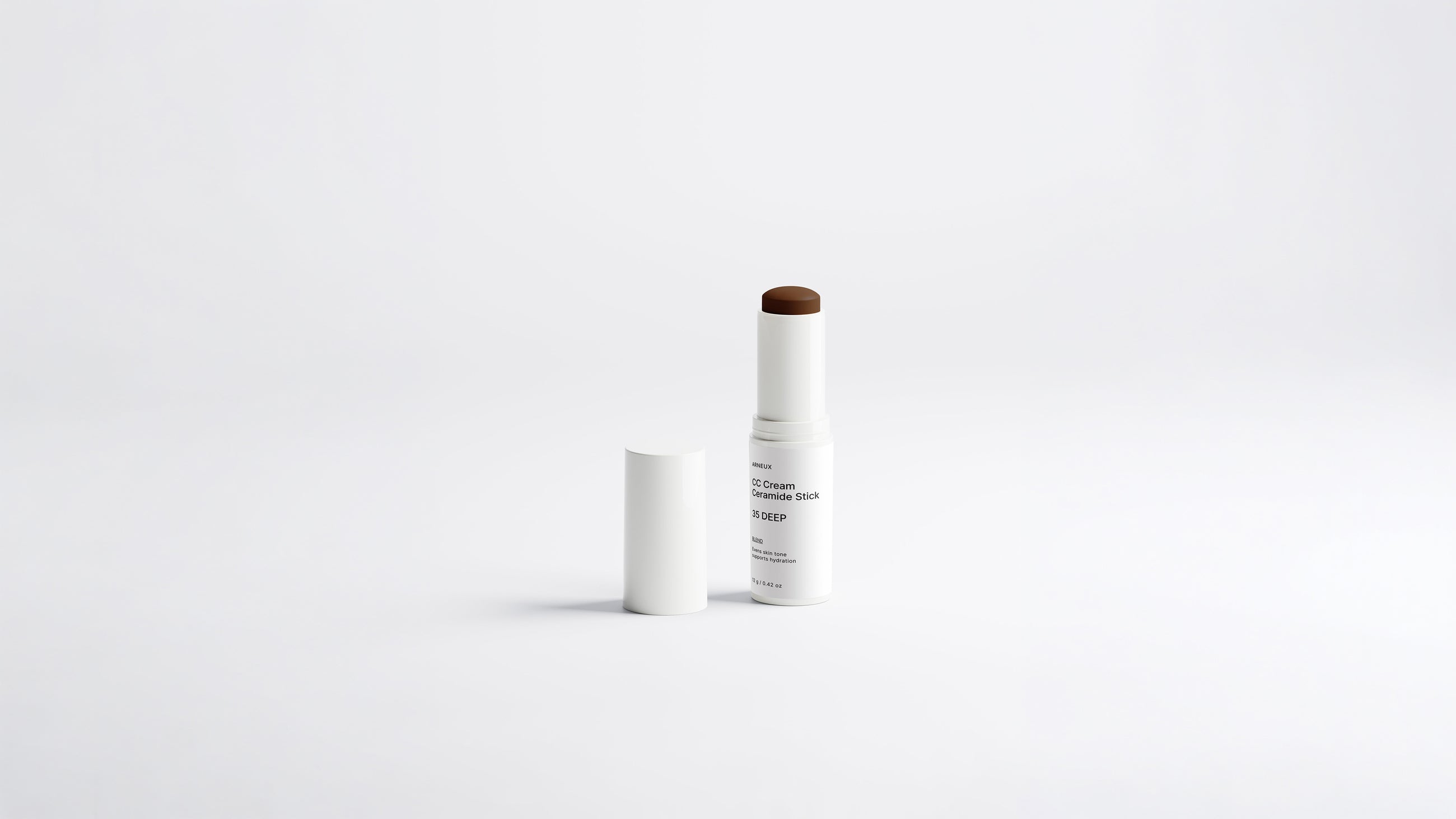 BLEND CC cream ceramide stick shade 35 Deep extended beside cap on white background