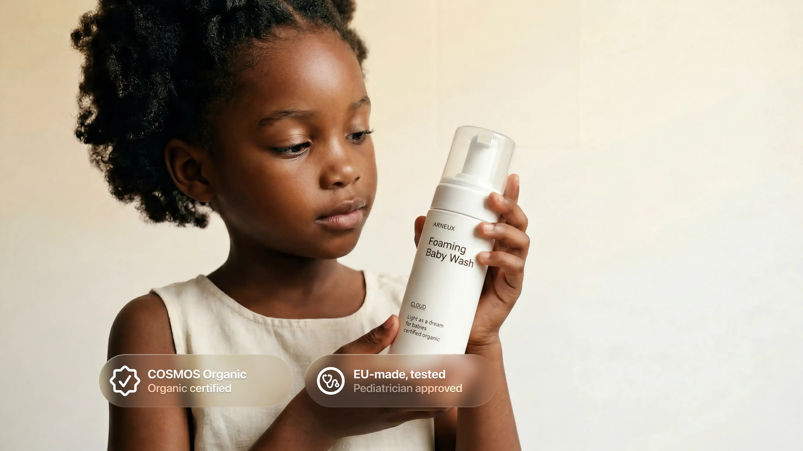 Young girl holding CLOUD baby wash, COSMOS Organic certified EU-made tested pediatrician approved callouts