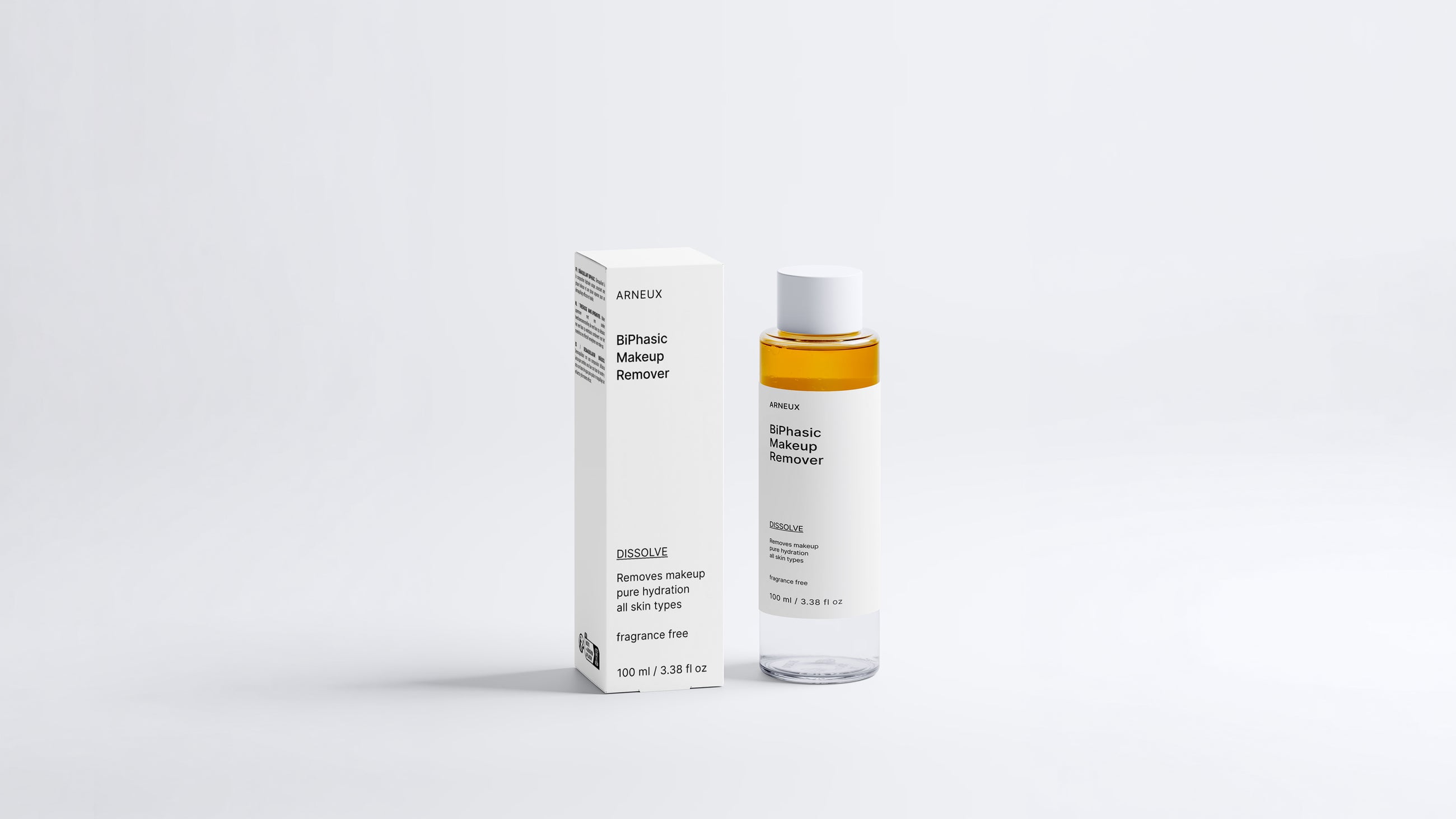 DISSOLVE biphasic makeup remover bottle and box packaging, full product set on grey background