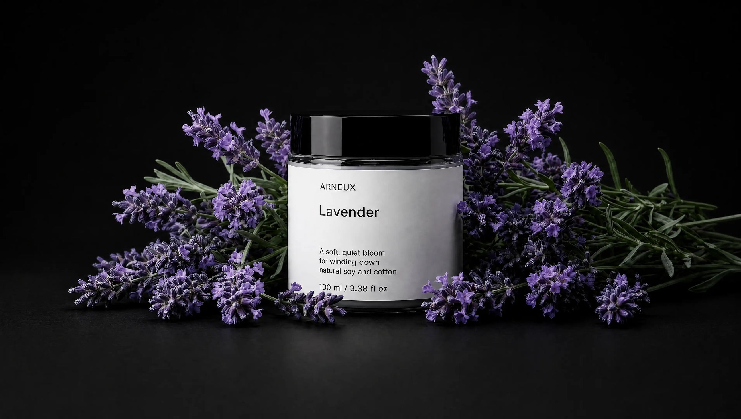 LAVENDER travel candle surrounded by fresh purple lavender sprigs on black background