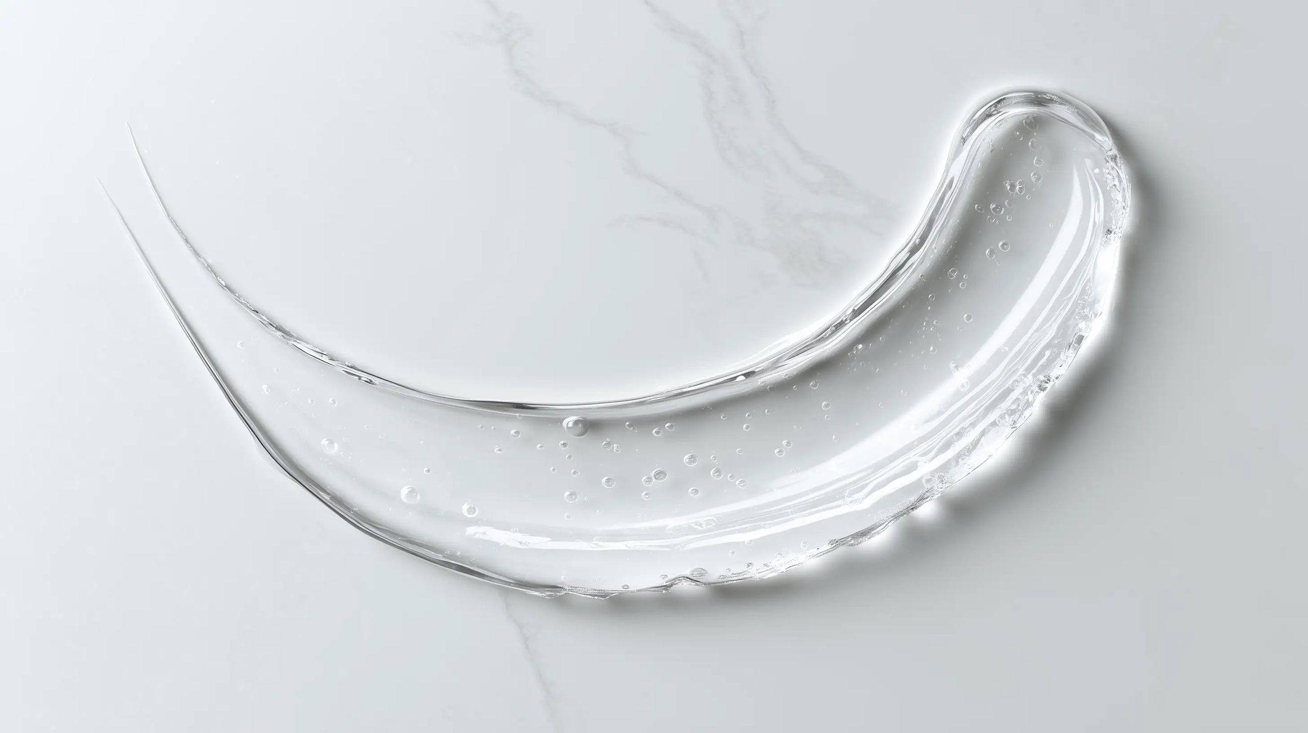 Caffeine gel booster clear lightweight gel texture swatch on white marble, instant-absorbing consistency