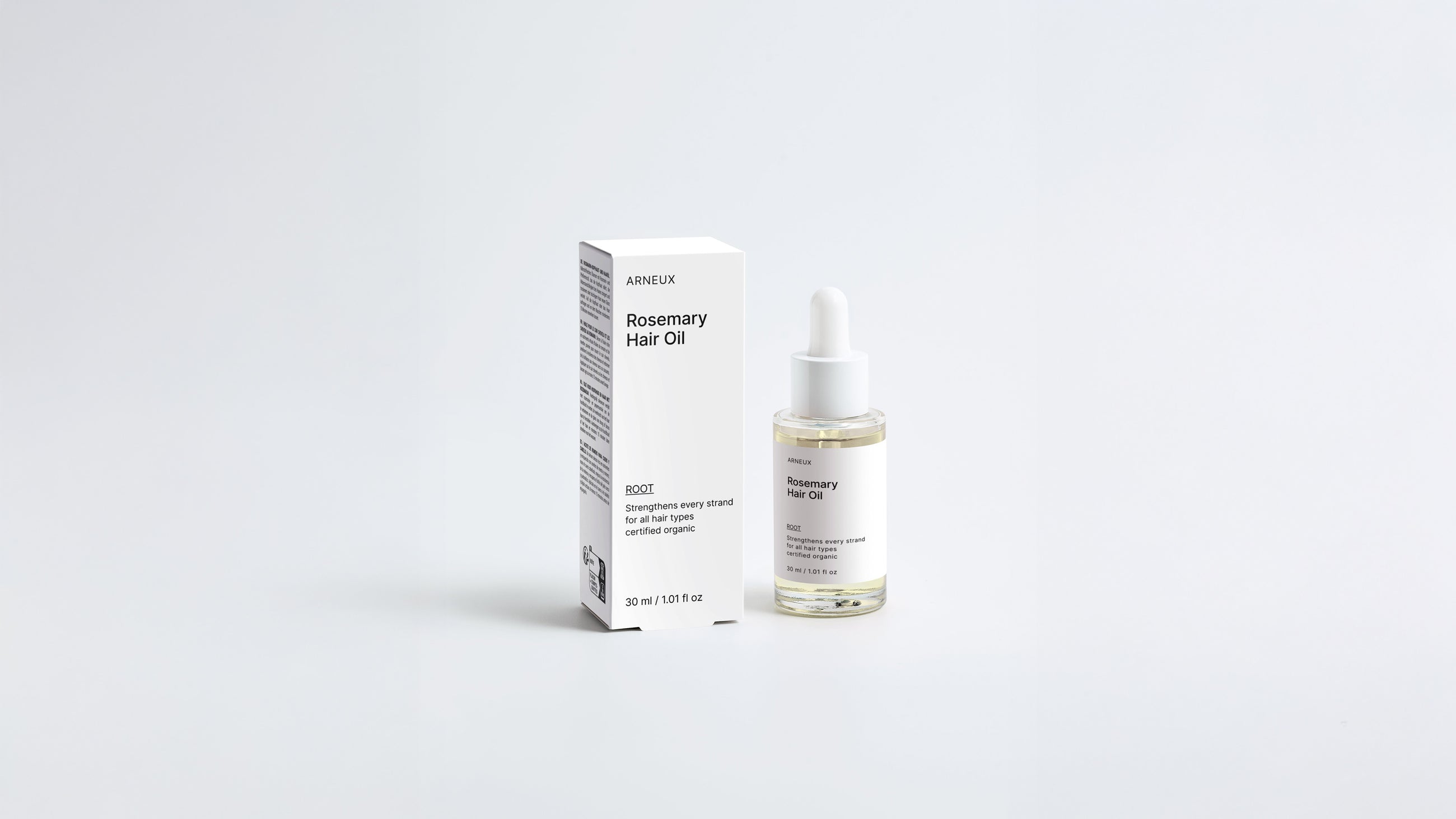 ROOT rosemary hair oil dropper bottle and box packaging set on grey background
