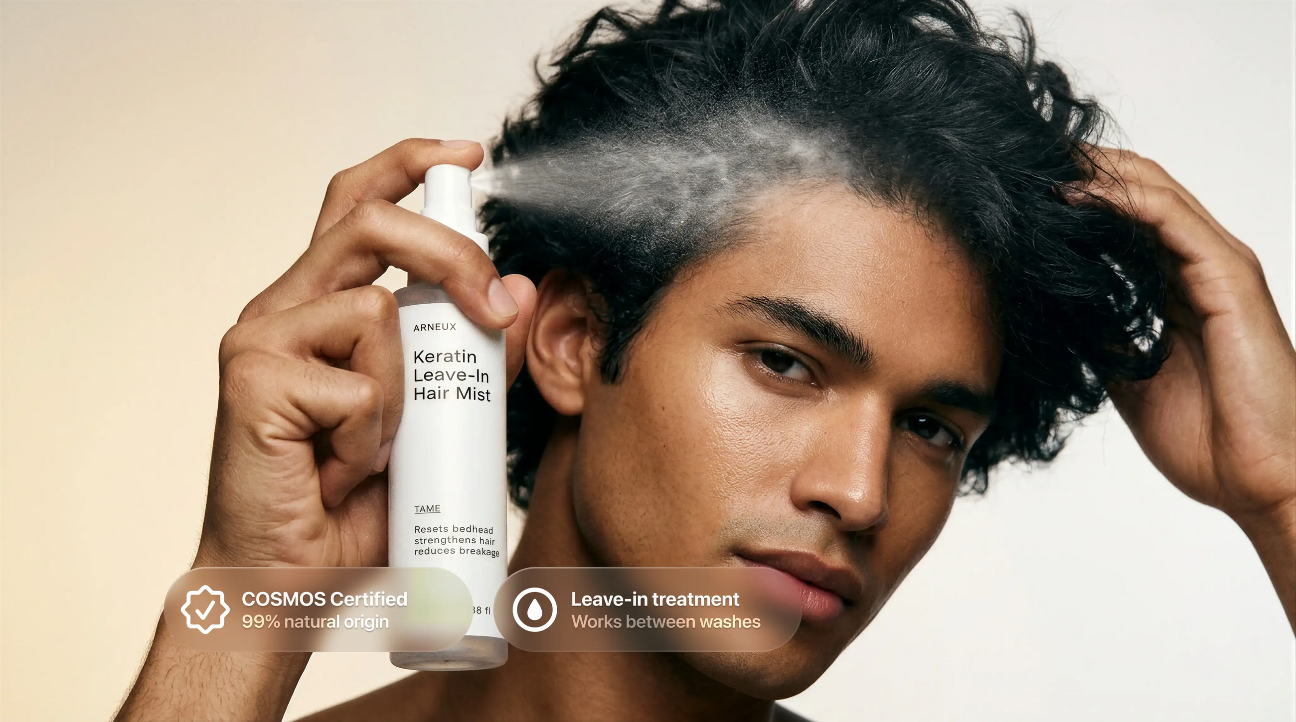 Man spraying TAME keratin leave-in mist into curly hair, COSMOS certified leave-in treatment callout