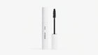 A white mascara tube labeled ARNEUX stands next to its open wand applicator with a black bristle brush, on a clean white background