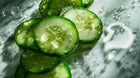 Fresh cucumber slices close-up, natural brightening ingredient in ARNEUX BALANCE organic hyperpigmentation routine