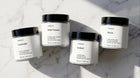 ARNEUX ILLUMINATE travel candle set flatlay, four natural soy wax candles made in Europe