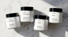 ARNEUX ILLUMINATE travel candle set flatlay, four natural soy wax candles made in Europe