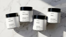 ARNEUX ILLUMINATE travel candle set flatlay, four natural soy wax candles made in Europe
