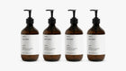 INDULGE The Shower Edit by ARNEUX, four organic body wash scents in amber bottles on white background