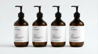 INDULGE The Shower Edit by ARNEUX, four organic body wash scents in amber bottles on white background