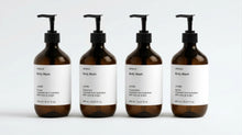 INDULGE The Shower Edit by ARNEUX, four organic body wash scents in amber bottles on white background