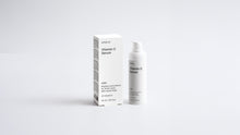 AURA vitamin C serum bottle and box packaging set on grey background