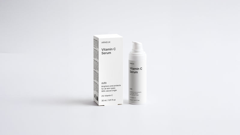 AURA vitamin C serum bottle and box packaging set on grey background