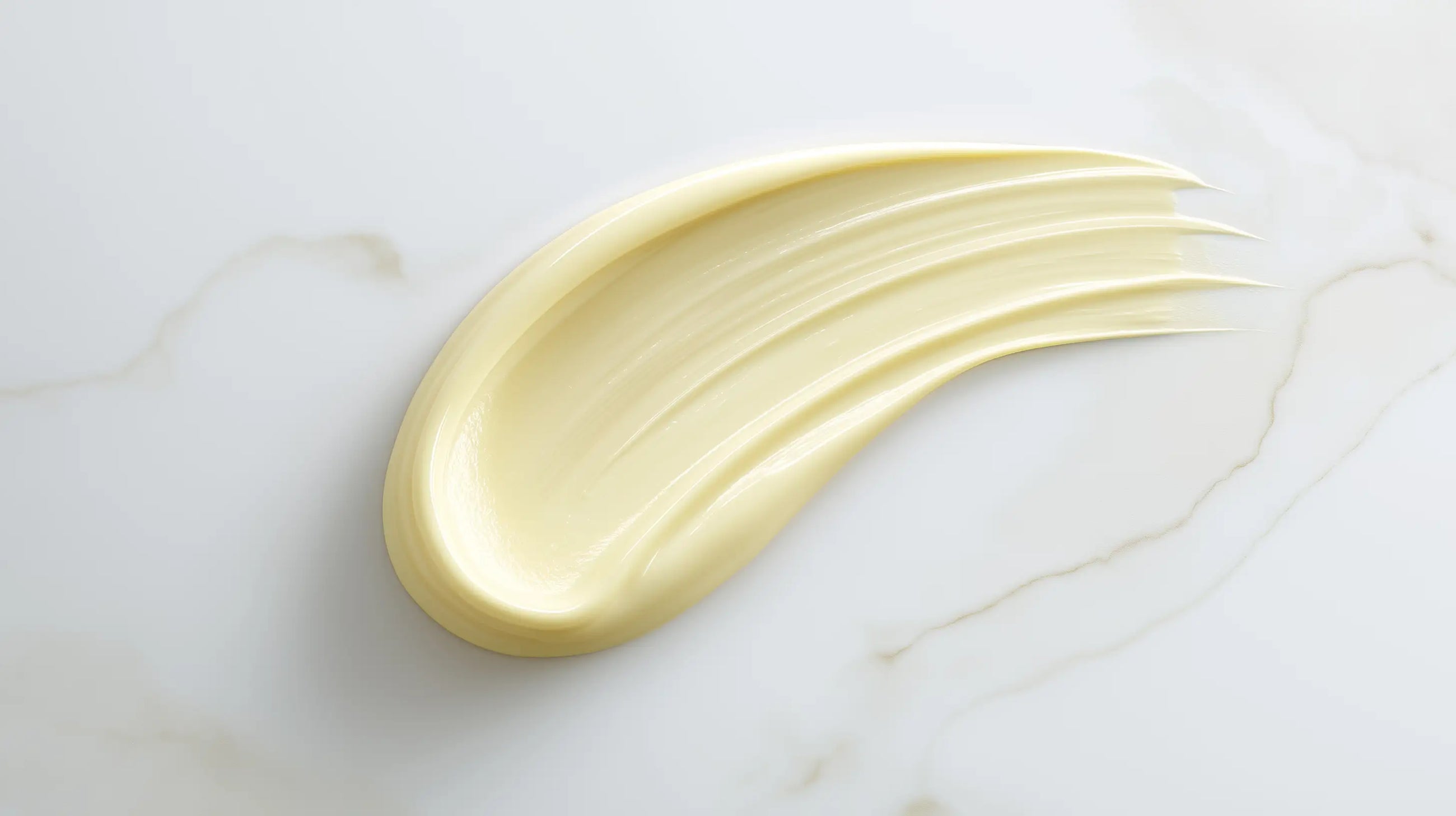 Vitamin C serum yellow-toned texture swatch on white marble, lightweight fast-absorbing consistency