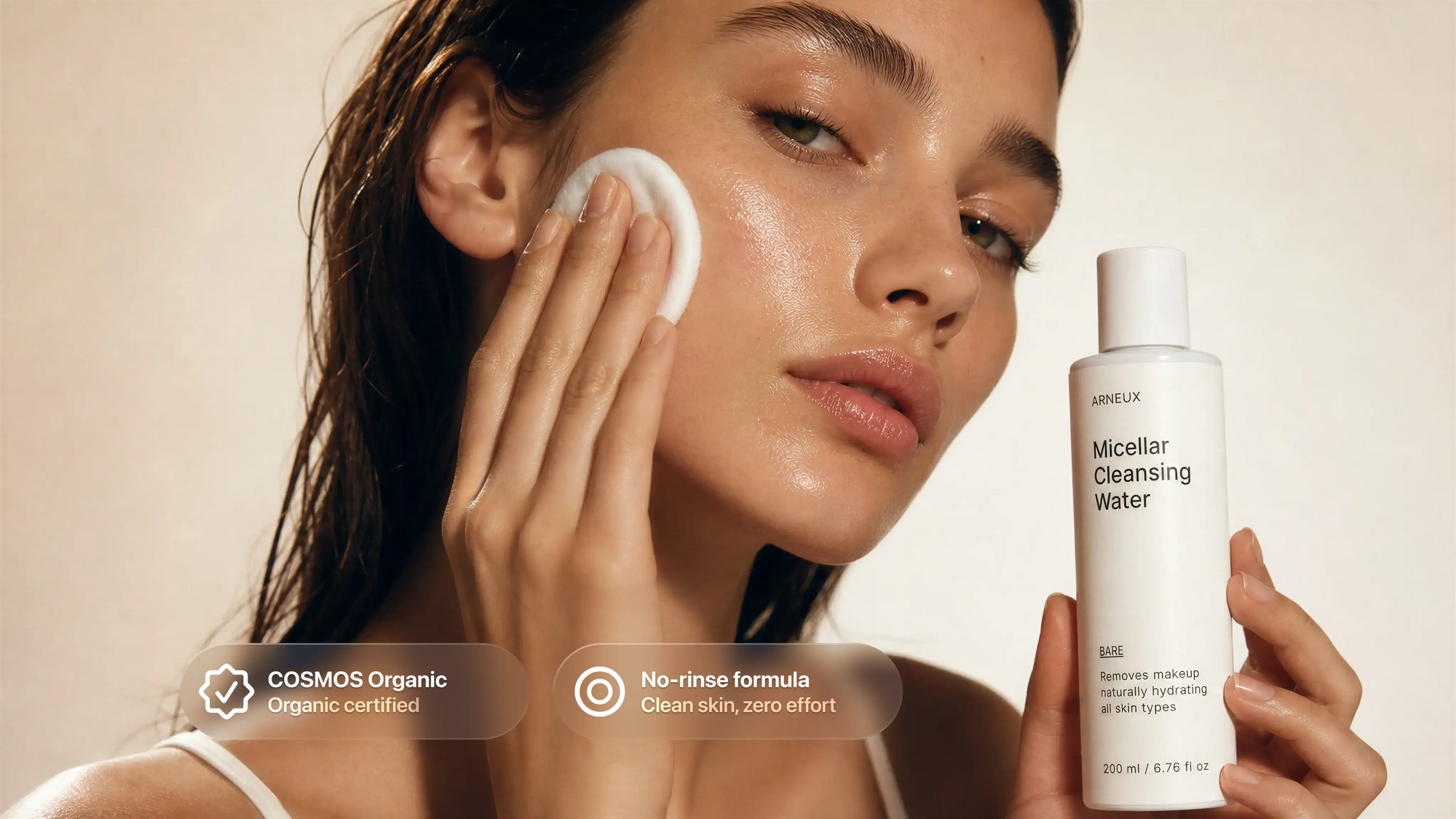 Woman with damp dewy skin applying no-rinse micellar water with cotton pad, COSMOS certified
