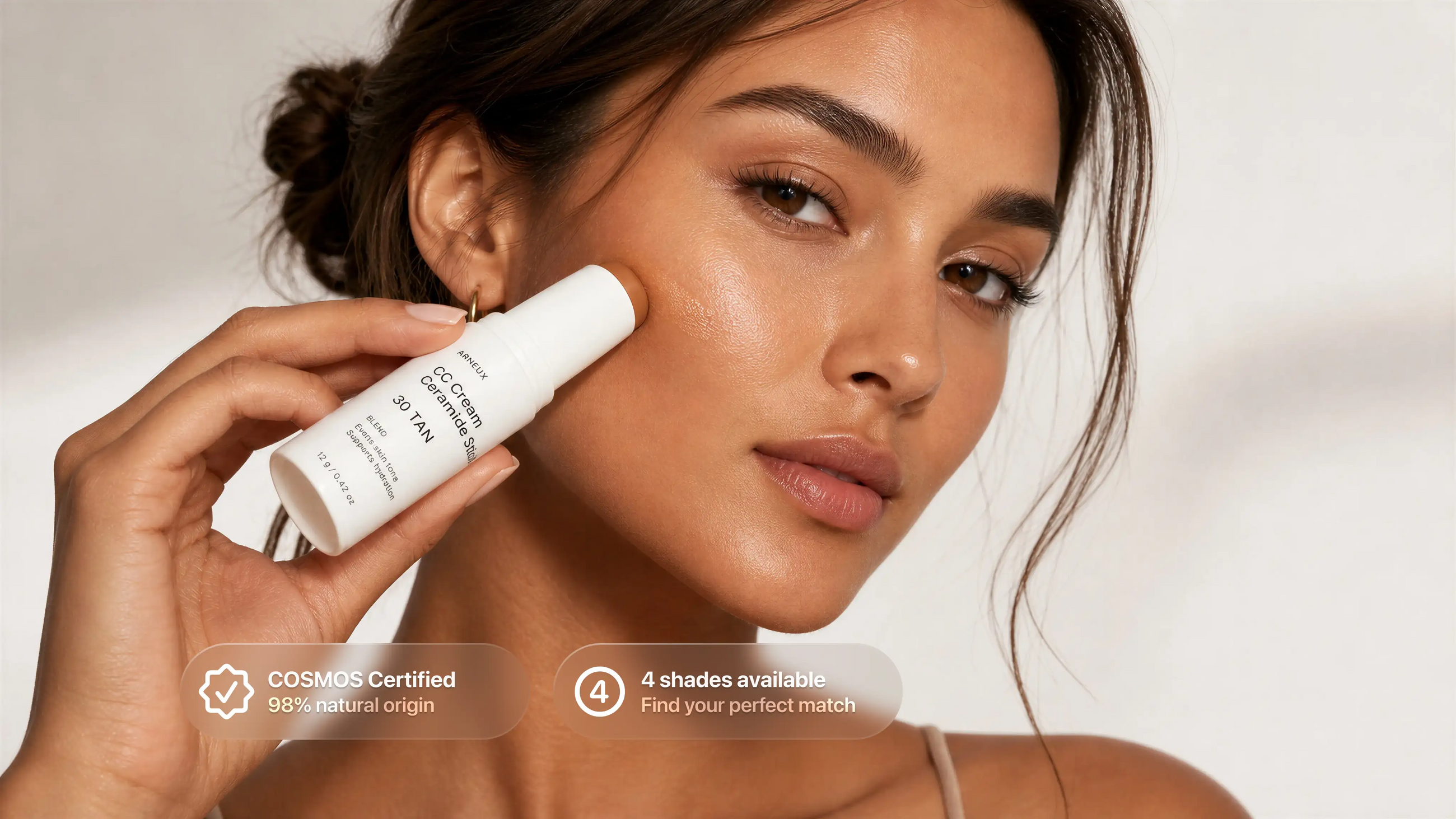 Woman blending BLEND CC ceramide stick into cheek, COSMOS certified 4 shades available callout
