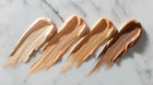 Four BLEND CC cream ceramide stick shades swatched light to deep on white marble surface