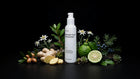 CALM moisturizer bottle with ginger, bergamot, juniper berries, argan and edelweiss on black