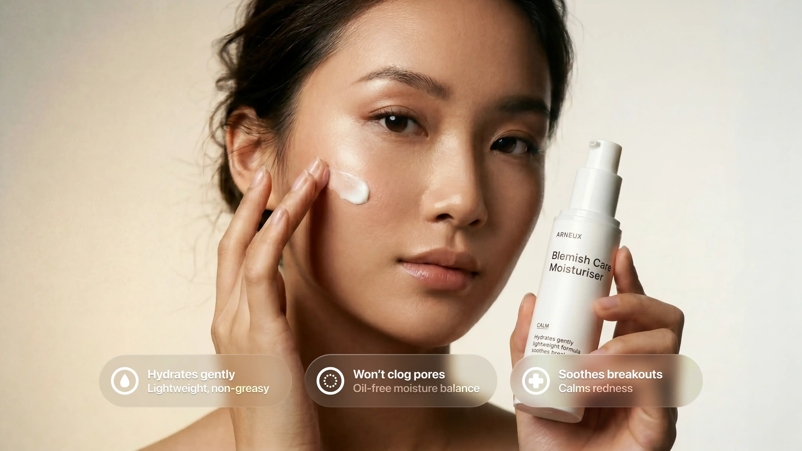Woman applying CALM blemish moisturizer to cheek, hydrates gently and soothes breakouts callouts