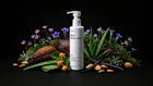 CARE baby body lotion bottle with coconut, aloe vera, purple florals and almonds on black background