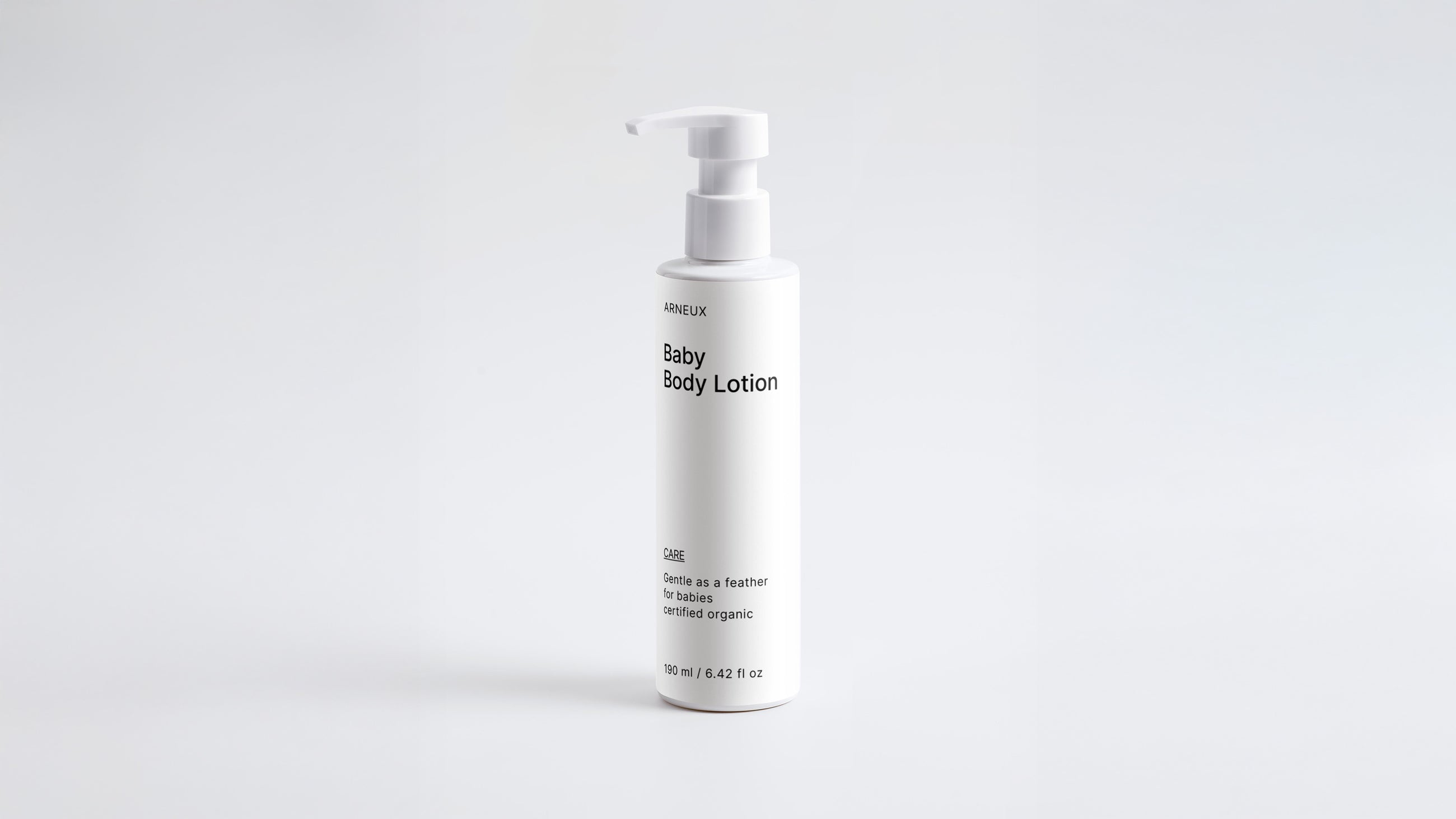 Arneux CARE baby body lotion pump bottle, front label view on light grey background
