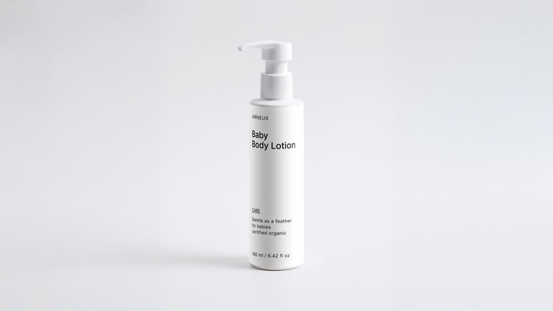 Arneux CARE baby body lotion pump bottle, front label view on light grey background