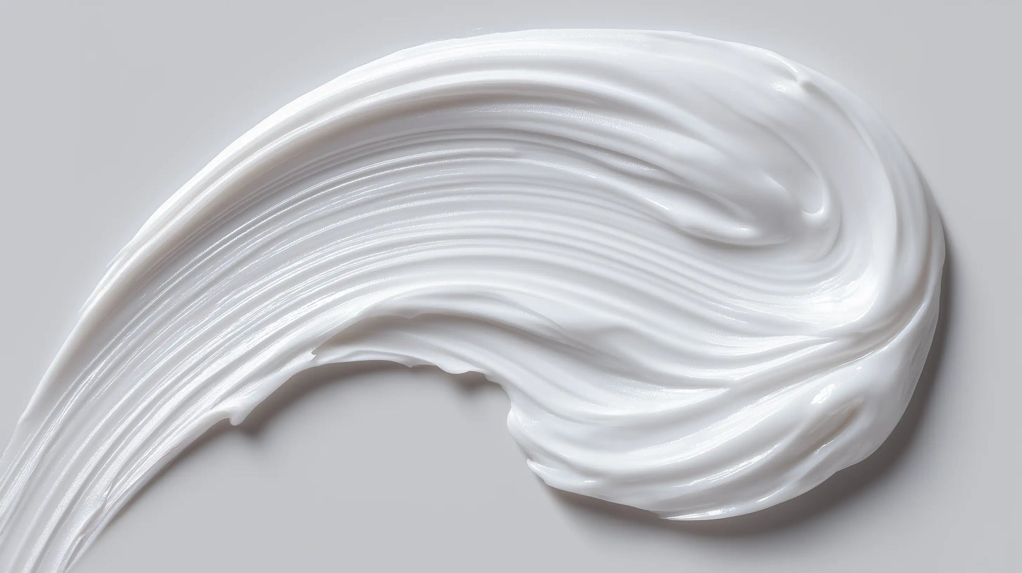 CARE baby body lotion rich white cream texture swatch, fast-absorbing gentle formula close-up