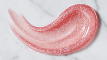 Radiant glow facial wash pink gel-to-foam texture swatch with bubbles on white marble surface