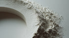 Kaolin clay powder dusted on curved white surface, purifying mineral ingredient in CLEAR face wash