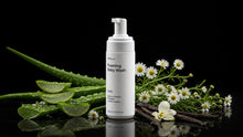CLOUD foaming baby wash bottle with aloe vera, chamomile flowers and vanilla on black background