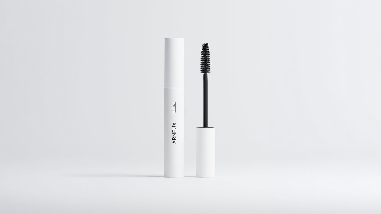 Arneux DEFINE lengthening volumizing mascara white tube with black wand extended on grey background