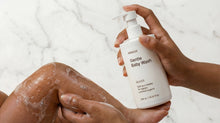 Hands applying DELICATE baby wash lather on marble surface, dermatologically tested ultra-gentle formula