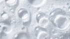 Clear water droplets and soap bubbles texture close-up, ultra-gentle tear-free formula from DELICATE baby wash