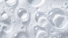 Clear water droplets and soap bubbles texture close-up, ultra-gentle tear-free formula from DELICATE baby wash