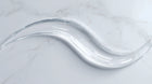 Clear oil-free hydrating gel swatch on white marble showing lightweight water-gel texture