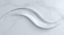 Clear oil-free hydrating gel swatch on white marble showing lightweight water-gel texture