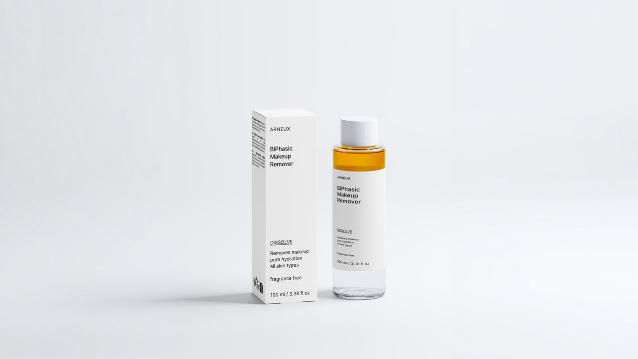 DISSOLVE biphasic makeup remover bottle and box packaging, full product set on grey background
