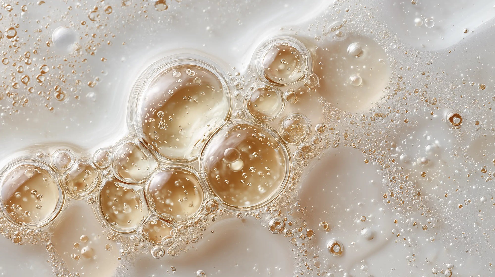 Golden organic oil droplets and water bubbles macro, COSMOS Organic certified 95% plant-based formula standard