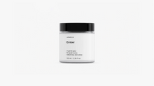 Arneux EMBER travel candle glass jar with black lid, sweet heather soy wax candle front view on grey background