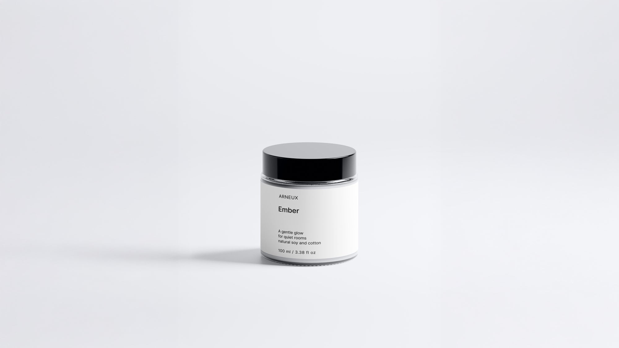 Arneux EMBER travel candle glass jar with black lid, sweet heather soy wax candle front view on grey background