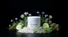 FLAWLESS clay mask jar with edelweiss, blue flowers, cucumber slices and green clay on black