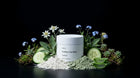 FLAWLESS clay mask jar with edelweiss, blue flowers, cucumber slices and green clay on black