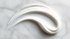 Retinol alternative serum smooth white texture swatch on marble, lightweight non-irritating consistency