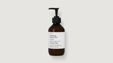 An amber glass pump bottle of ARNEUX hydrating body lotion with a black dispenser and a white label, centered on a light gray background