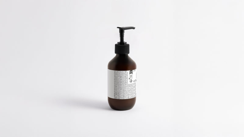 HYDRATE hydrating body lotion amber bottle side profile showing back label and pump detail