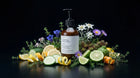 HYDRATE body lotion bottle with edelweiss, citrus, cucumber and wildflowers on black background