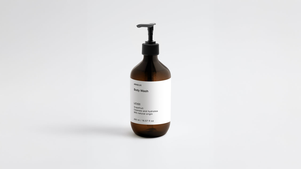 LATHER ginger body wash amber bottle, low three-quarter angle view on white background