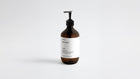 LATHER ginger body wash amber bottle, low three-quarter angle view on white background