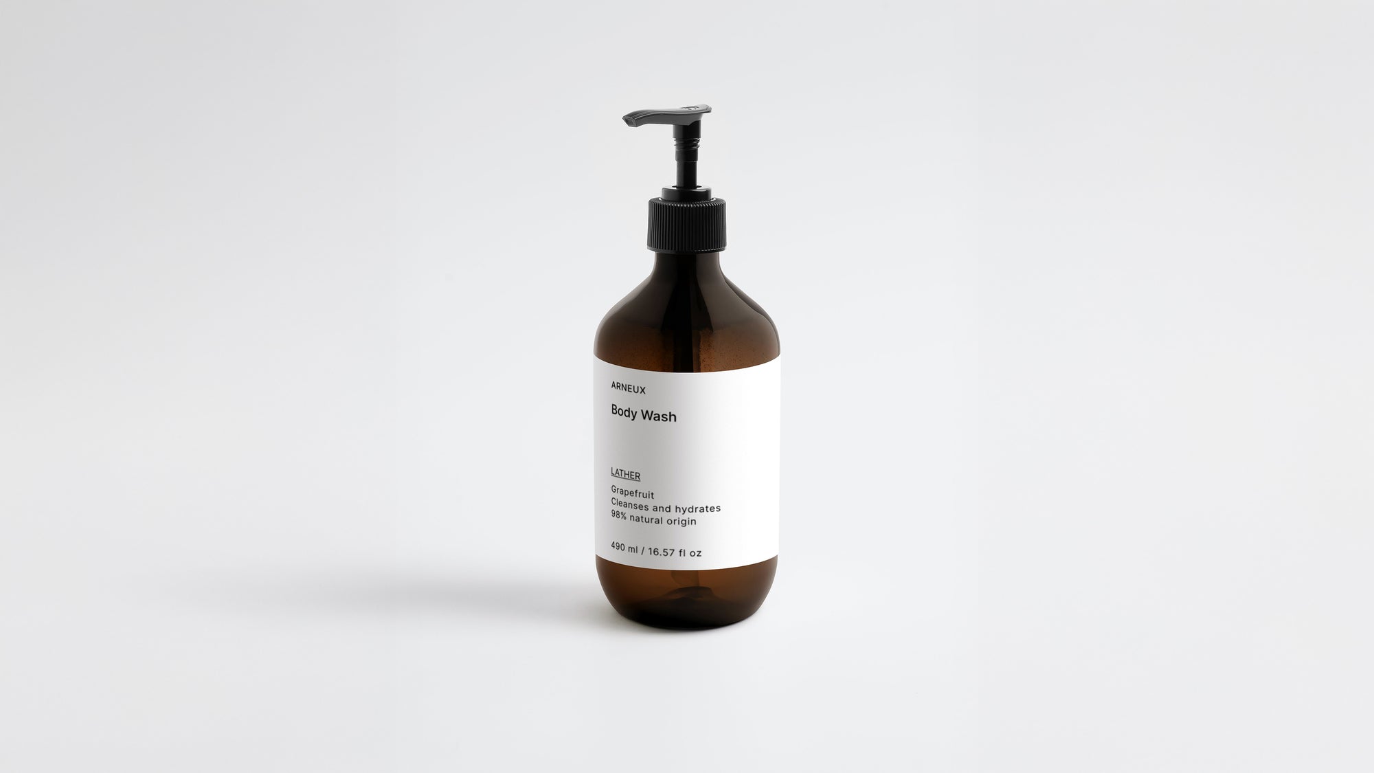 LATHER ginger body wash amber bottle, low three-quarter angle view on white background