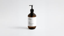 LATHER ginger body wash amber bottle, low three-quarter angle view on white background